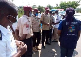 WHO and Ogun State Port Health Service staff address officers of the Federal Road Safety Corps on COVID-19 safety measures at the Idiroko border area in Ogun State. They also hand out protective materials including sanitisers and face masks/ WHO Nigeria