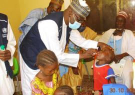 A WHO personnel vaccinating a child with Oral Polio Vaccine at Layin Kuka of Yindiski, Dogo Nini ward of Potiskum, Local Government Area, Yobe State on 29 October 2020