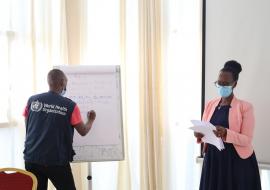 Dr. Alfred Rutagengwa (WHORwanda) and Mrs. Adeline Kabeja (RBC) organizing the IDSR review workshop participants into working groups.