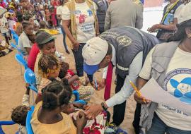 WHO vaccinating a child during the launch of the 2. Round of the polio campaign