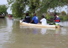 In flooded areas in South Sudan, WHO personnel use canoes to provide much-needed healthcare services. 