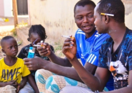 Two Adults smoking in the presence of children.