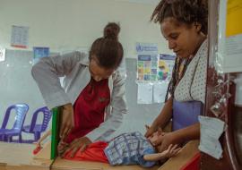 Mehonie the nurse updating the board with the newly admitted child's condition at the Stabilization Center (SC) to facilitate ongoing monitoring of the child's progress.