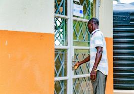 An Ebola survivor walks to the survivors' clinic in Kassanda