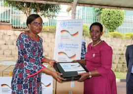 Dr Christine Musanhu, WHO Uganda OIC, handing over IT equipment to Dr Diana Atwine, the Permanent Secretary at the Uganda's Ministry of Health