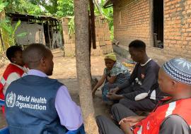 A WHO staff member conducting a community engagement session