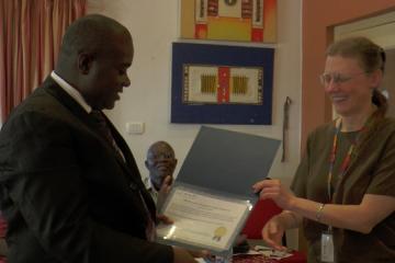 The Assistant Minister receiving the HINARI License Certificate