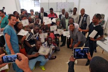 Group of graduates with their certificates from the Ministry of Health and Social Welfare.