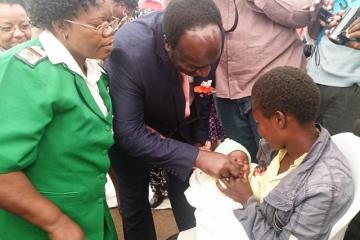 Dr Okello administering vaccine at launch
