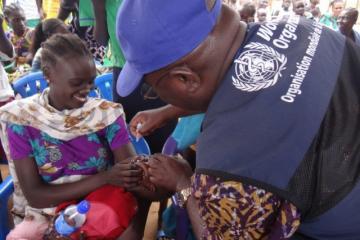 Dr Bimpa Lupanzula, gives an anti-polio drop to a child during the campaign launch at Jebel Dinka