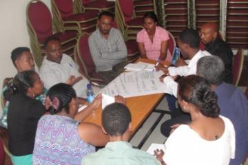 Participants engage in group work during the ENGAGE-TB sensitization workshop.