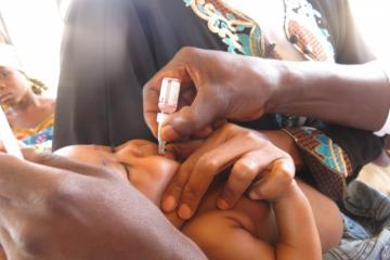 A child receiving oral polio vaccine