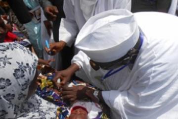 Governor vaccinating a baby with OPV