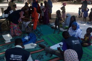 Mobile Hard-to-Reach team providing integrated basic primary healthcare services in a Borno community. M Shafiq/WHO