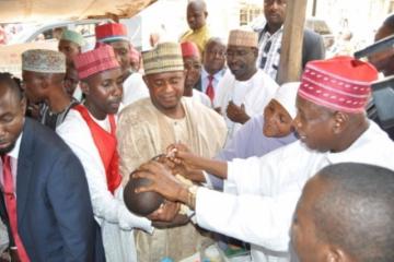 Governor Abdullahi Ganduje of Kano immunizing a child during the June 2015 IPDs