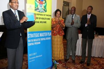 The Minister of Health and Social Welfare, Hon. Dr. Hussein Mwinyi holding the launched national master plan for NTD control and elimination