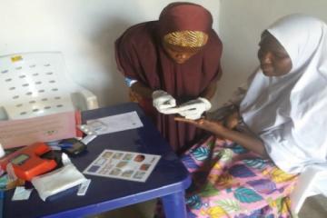 Midwife doing routine malaria Rapid Diagnostic Test (RDT) screening to a pregnant woman as an Ante-Natal Care service in Garba Buzu IDP Camp MdM