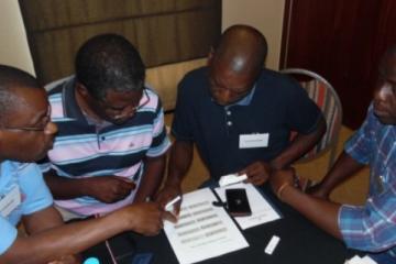 Malaria Case Investigators discussing various scenarios of reading a RDT