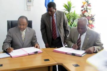 The WHO Representative, Dr. Rufaro Chatora and the Minister for Health and Social Welfare, Hon.Dr Hussein Ali Mwinyi signing certificates of transfer