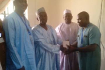 WHO State coordinator presenting oily chloramphenicol to the Kebbi State Commissioner of Health.