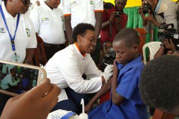The Minister of Health, Dr Diane Gashumba vaccinating a pupil on HPV