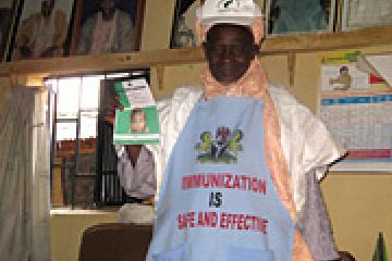 Kekun Nahuche displaying measles campaign materials