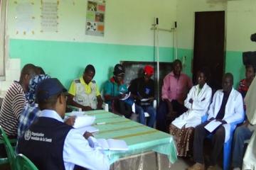 WHO and Ministry of Health staff discussing with nurses