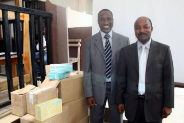 De G à D, le Dr Abdoulaye Yam, EPI et le Dr Désiré Lassegué, SGA à côté du lot de consommables pour le laboratoire offert par l’OMS