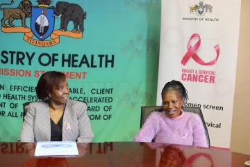 Dr Susan Tembo WHO Representative Eswatini  (left) at the event looking on while Fikile Hlatjwayo narrates her cancer journey.  