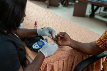 A blood glucose test measuring the amount of glucose in a sample blood