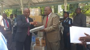 The WHO Representative, Dr. Rufaro Chatora handing over an ECG machine to the Chief Medical Office