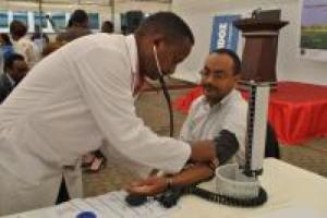 Dr Kesetebirhan Admasu, Minister of Health, gets his blood pressure checked at the launch event on 17 April 2014.