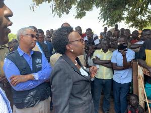 Minister of Health Dr Jane Ruth Aceng (black suit) addresses a gathering in Arua district about Ebola Virus Disease. Looking on is the WHO Representative in Uganda, Dr Yonas Tegegn Woldemariam (WHO branded jacket) 