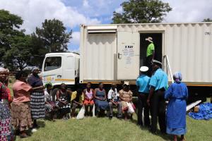 People queuing for TB screening in one of the mobile x ray vans 