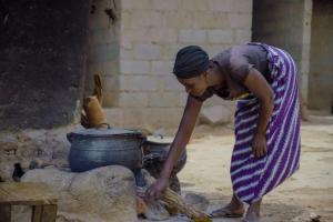 Fatimah Saliu, uses firewood to prepare meals for her family.