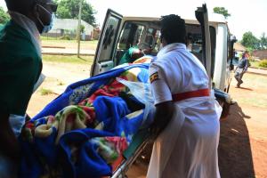 Nurses help to put an expectant mother into the ambulance upon referral to the next level health facility. Ambulance services have made it possible for such timely referrals.