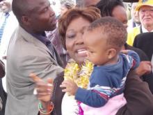04 Hon Beth Mugo holding one of the children attending the launch