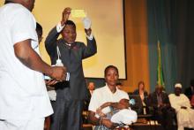 HEAD OF STATE HIS EXCELLENCY DR THOMAS BONI YAYI SHOWS A CHILDS VACCINATION CARD