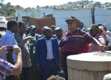 Head of the State with the Minister of Health at one of the drains which were unblocked as part of ongoing efforts to reduce the risk of active transmission