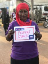 Dr Kasule Hafisa looks holds a commitment placard on the cancer day 