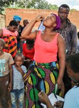 A woman taking the the Oral Cholera Vaccine during the first round of the campaign in Lilongwe