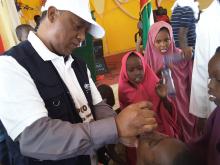 WHO Colleague vaccinating a child during the launching of mOPV2 vaccination