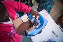 The vaccine is store in a vaccine box with ice packs to keep them at the right temperature unto the time it is administered to the beneficiaries. Photo credit: WHO/M. Duff