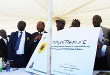 Honorable Minister Moyo showing off the signed pledge to fight tobacco smoking and use of drugs and illicit drug trafficking