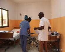 Staff members help a patient at CNRD, June 2019