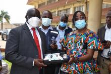 The Honorable Minister of Health, Dr Wilhelimina Jallah symbolically receiving the medical supplies from WHO Representative- Dr Peter Clement 