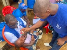 WHO Liberia  Expanded Program on Immunization Officer administers the vaccine during the launch of the nationwide polio vaccination campaign in Liberia