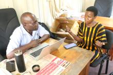 Minsa Bakimenze interacts with a service provider