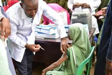 Health care work is seen vaccinating a student during the flag off of HPV campaign in Borno state. 