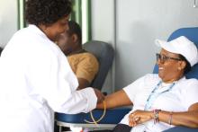 Mavie Ndama drawing blood from blood donor